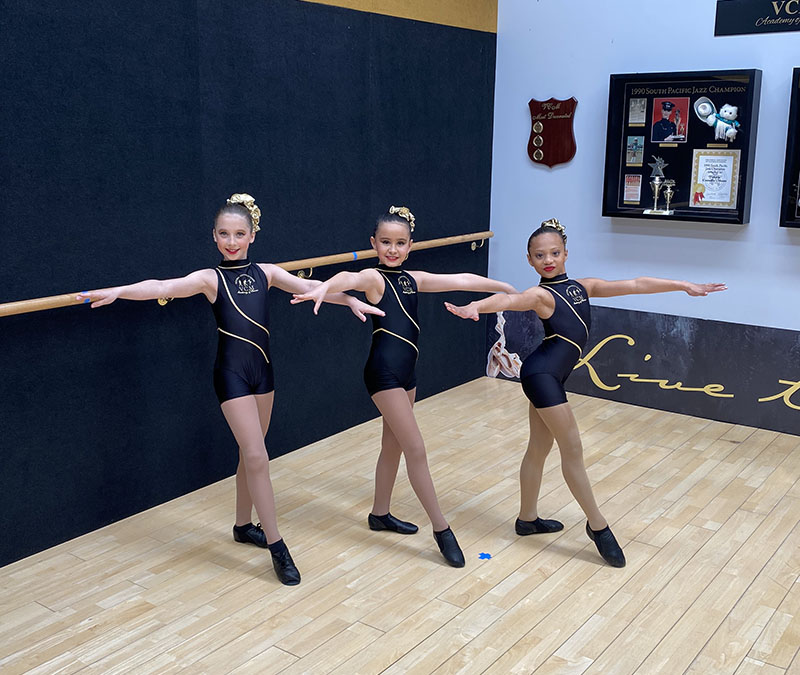 Junior jazz dance classes at VCM Academy students pose together in modern dance studio